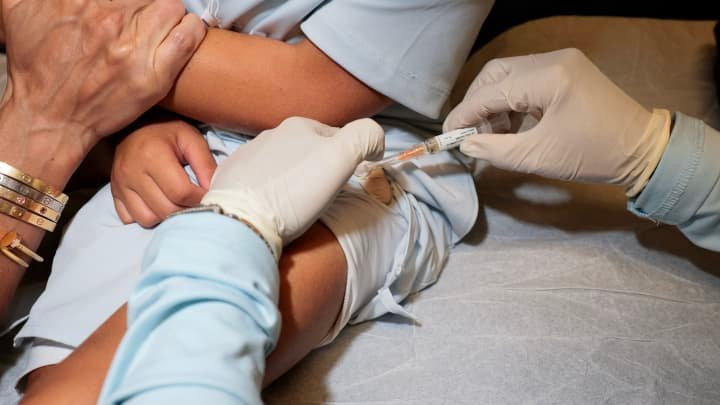 A Medical Assistant gives a measles, mumps and rubella, vaccination to a young person at the pediatric office of Dr. Gary M. Kramer on Aug. 13, 2026, in Coral Gables, Florida.