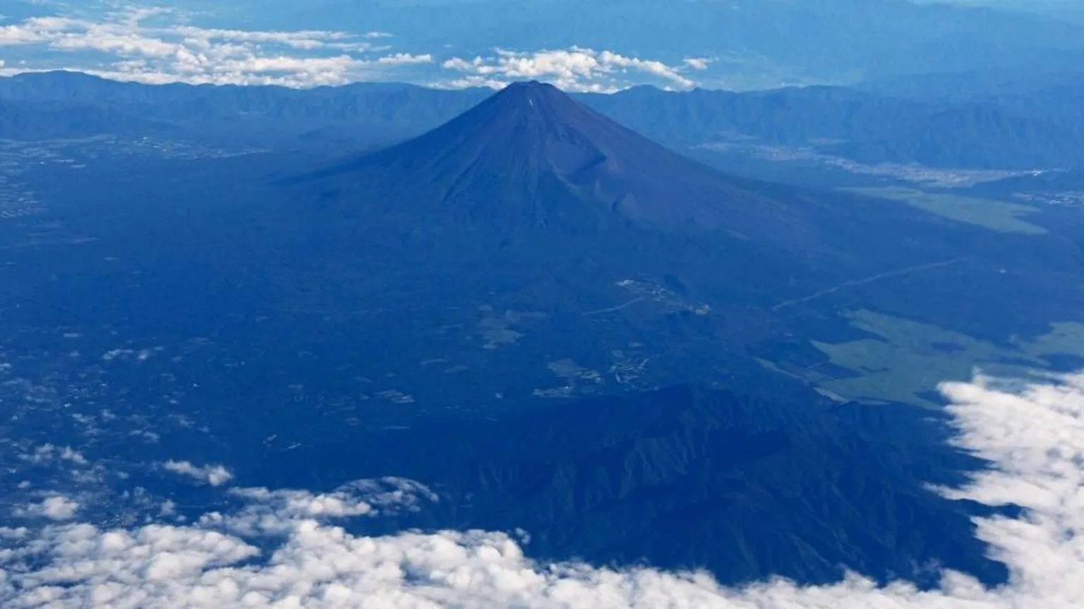 Reuters Mount Fuji is pictured from the skies with a ring of white cloud bordering the frame of the image