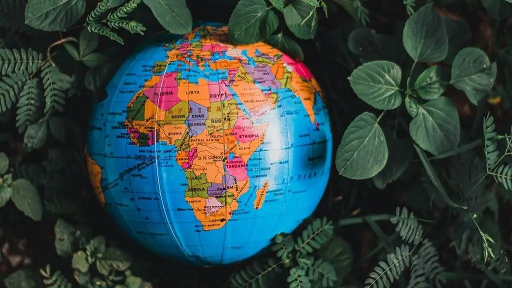 Globe in green leaves with map of Africa in view [Photo: Nothing Ahead]
