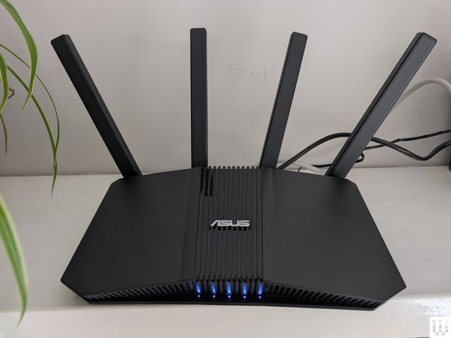 Asus RTBE58U a black angular wifi router with 4 antennae sticking up from the back