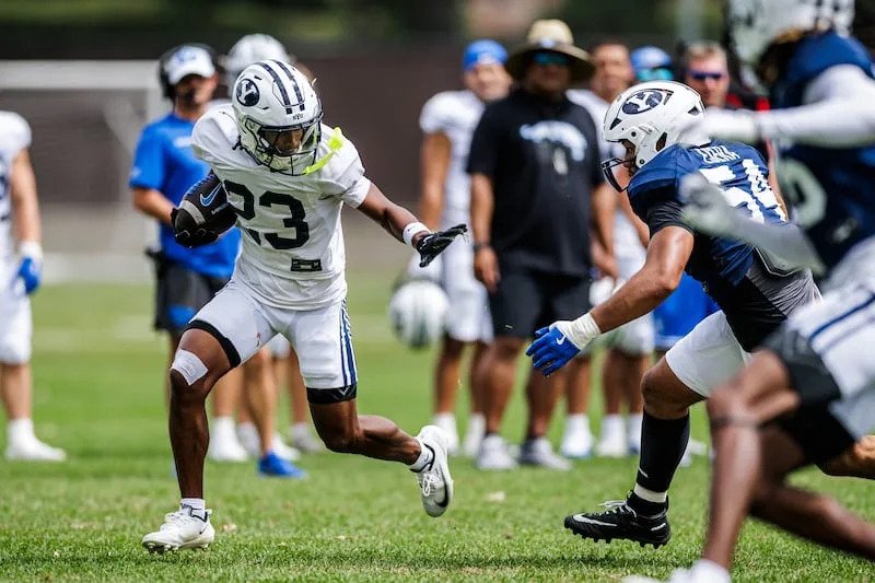 BYU freshman receiver Terrance Saryon prepares to stiff arm a defender during fall camp on Aug. 18, 2026, in Provo. | Aaron C