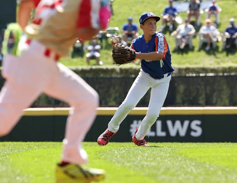 Shortstop Jack McAdams of Hamilton West Side (Great Lakes region) throws out the runner at first base for Henderson, Nevada, (Mountain region) at the Little League Baseball World Series at Howard J. Lamade Stadium in South Williamsport, Pennsylvania, Friday, Aug. 21, 2026.