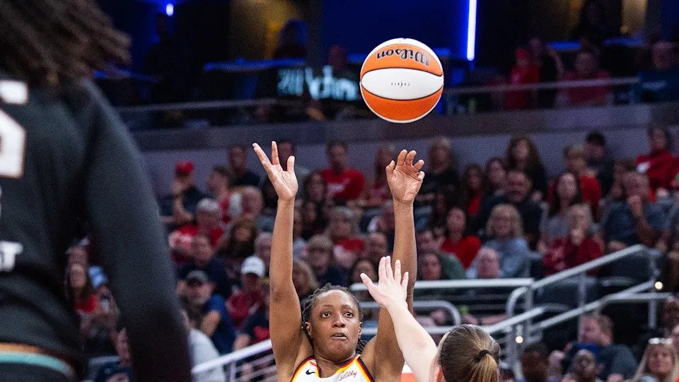 Aug 11, 2026; Indianapolis, Indiana, USA; Indiana Fever guard Kelsey Mitchell (0) shoots the ball while New York Liberty guard Sabrina Ionescu (20) defends in the second half at Gainbridge Fieldhouse.