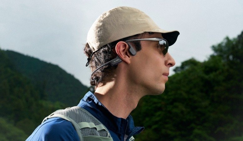 A man ears wraparound earbuds.
