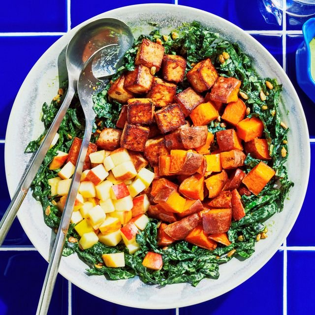 Seared tofu cubes roasted sweet potatoes and chopped Honeycrisp apples on a bed of kale and roasted salted sunflower...