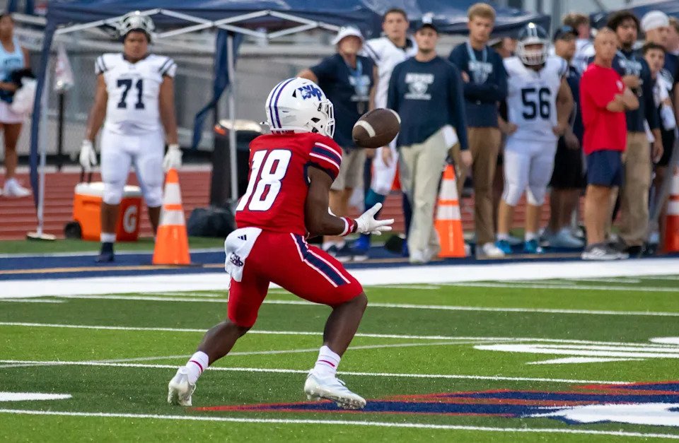 Wellen Park High School held its inaugural football game on Friday, Aug. 14, 2026 by hosting the North Port Bobcats. The Eagles won 45-7. Curtis Bowdre (18) hauls in a pass.