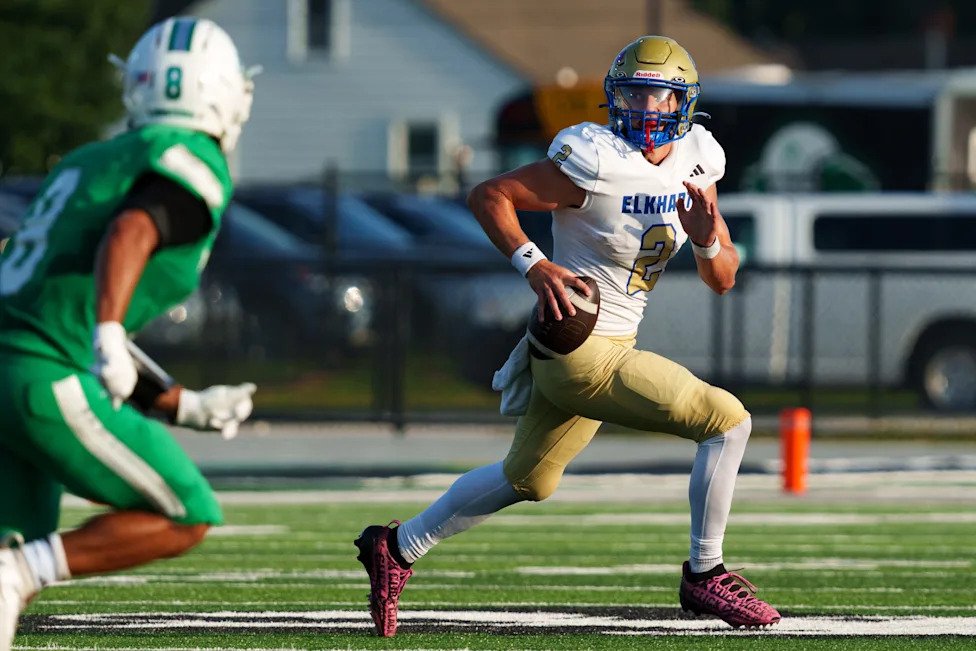 Elkhart's Micah Jarrell (2) scrambles during an IHSAA football game between Concord and Elkhart at Concord High School on Fri