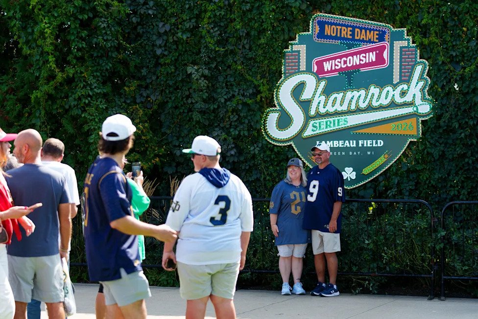Fans pose for photos before a NCAA football game between Notre Dame and Wisconsin at Lambeau Field on Sunday, Sept. 6, 2026, 