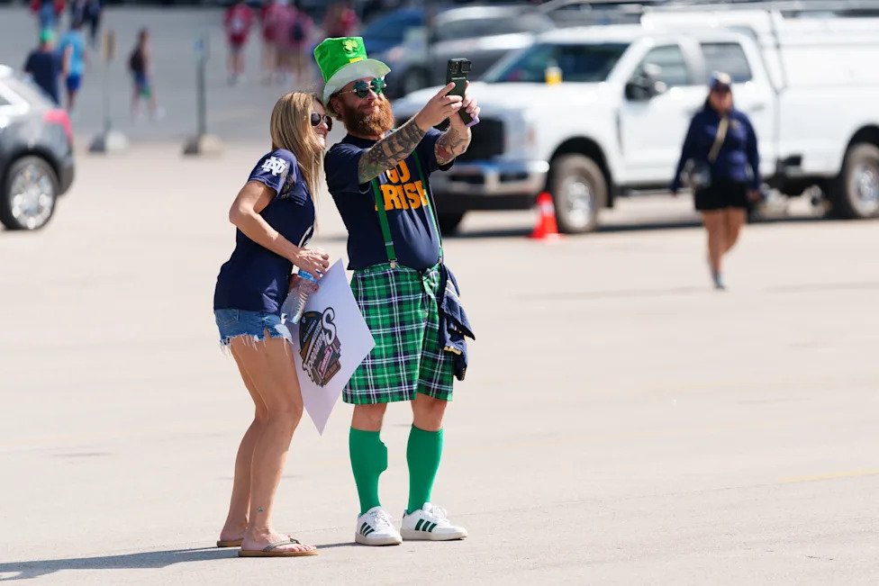 Favre Donnelly, left, and Jay Donnelly, pose for a photo before a NCAA football game between Notre Dame and Wisconsin at Lamb