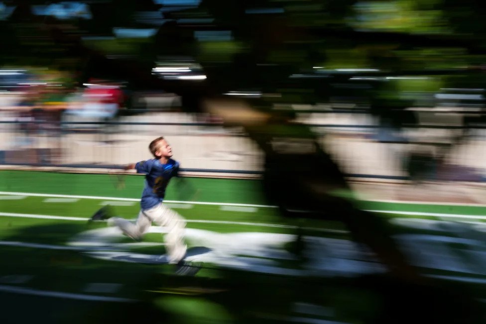 Jeffery Martin, 11, from Grand Rapids, MI, runs a 40-yard-dash outside Lambeau Field before a NCAA football game between Notr