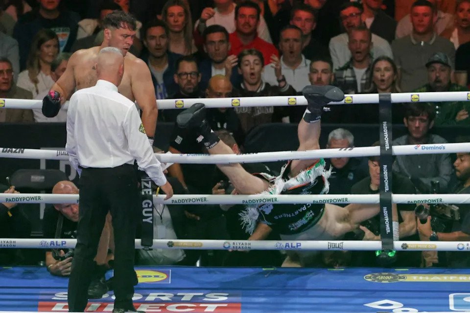 Carty tumbling out of the ring in round one (AP)