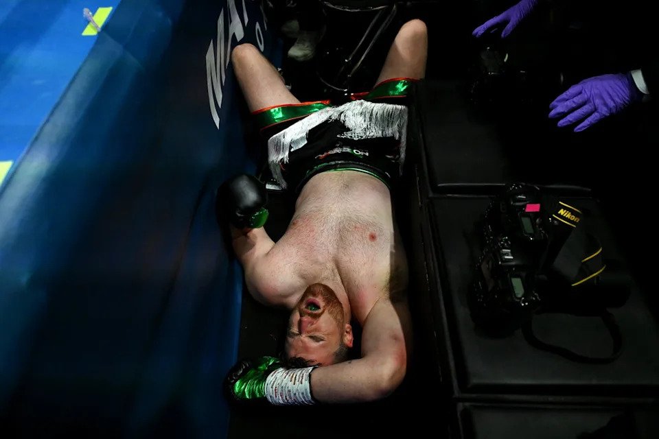 Thomas Carty after falling out of the ring against Dave Allen (Getty)