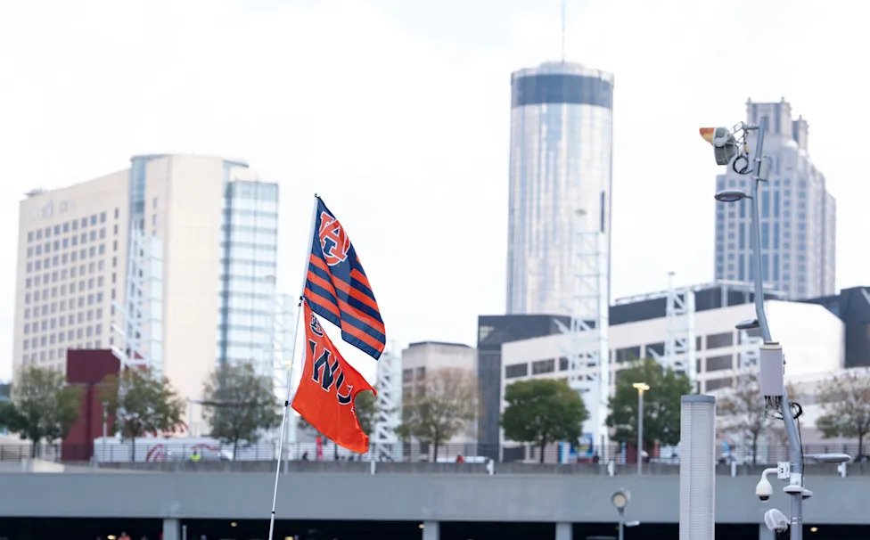 Fans hoist flags at tailgates before Auburn Tigers take on Baylor Bears in the Aflac Kickoff Game at Mercedes-Benz Stadium in