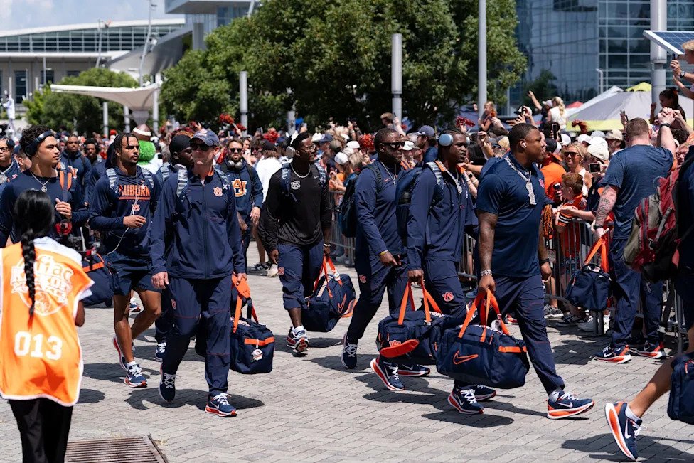 Auburn Tigers players arrive during Tiger Walk before Auburn Tigers take on Baylor Bears in the Aflac Kickoff Game at Mercede