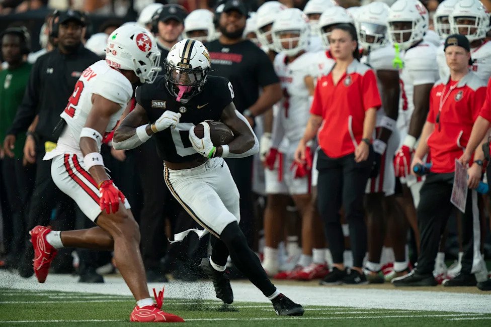 Vanderbilt wide receiver Junior Sherrill (0) is pushed out of bounds by Austin Peay defensive back Trevor Hardy (22) during t