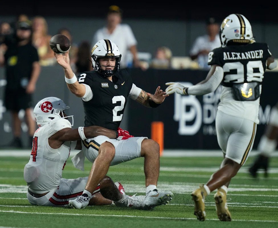 Vanderbilt quarterback Jared Curtis (2) throws a completion while being taken down by Austin Peay linebacker Jefferson Bretan