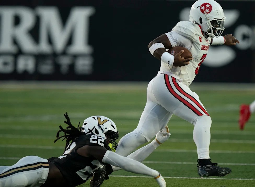 Austin Peay quarterback Chris Parson (3) defensive back Markell Redding (3) eludes the tackle of Vanderbilt linebacker Bryce 