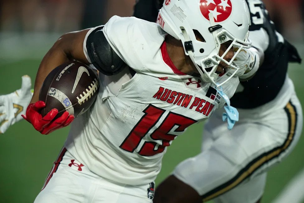 Austin Peay wide receiver Denver Harper (15) has his facemark grabbed by Vanderbilt defensive tackle Mike Diatta (15)during t