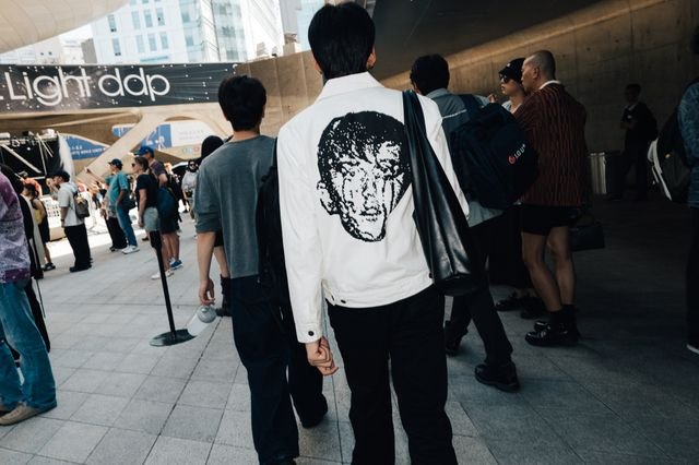 Image may contain Person Walking Clothing TShirt Pants Adult Shirt Sleeve Hat Backpack Bag Footwear and Shoe