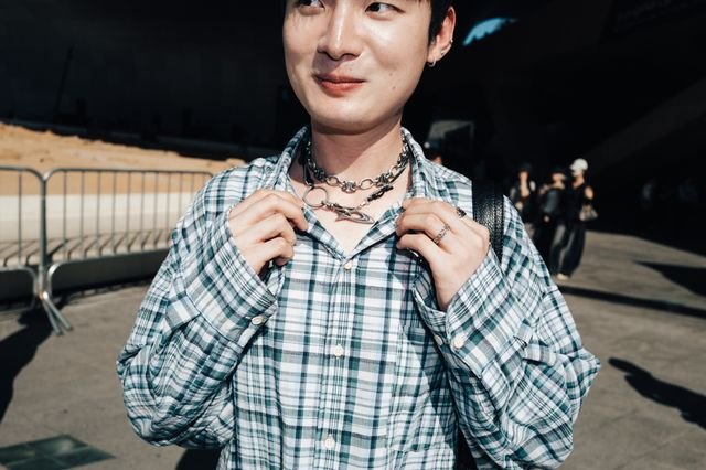 Image may contain Clothing Sleeve Accessories Jewelry Necklace Pendant Dimples Face Head Person and Body Part