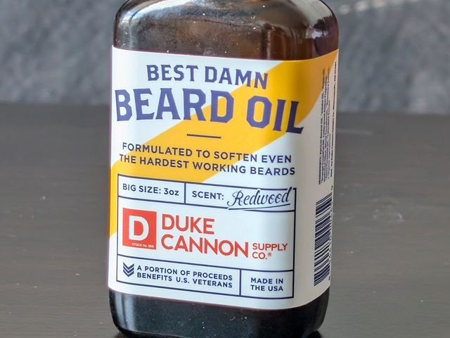 Duke Cannon Supply Co Best Damn Beard Oil a dark bottle with a label for the redwood scent