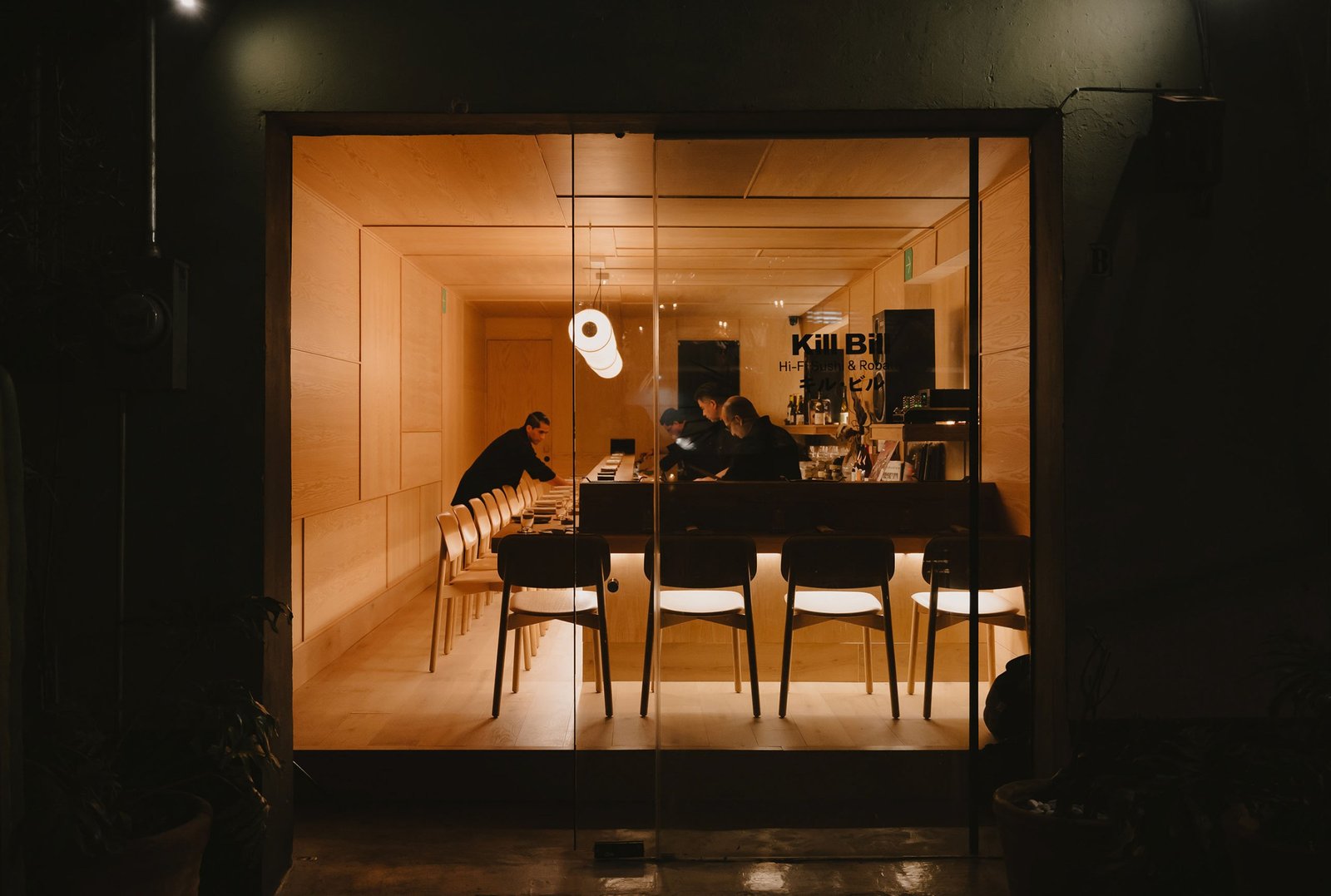 Staff set up inside a sushi bar.