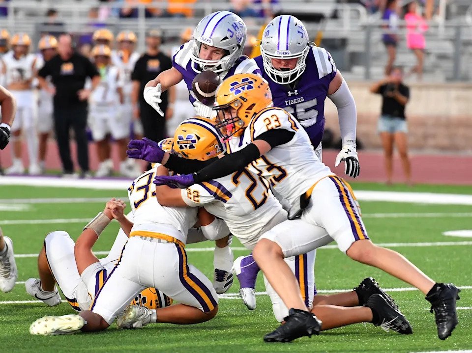 Merkel defenders tackle Jacksboro's Ryder Davis during a game on, Friday, Oct. 9, 2026, at Jacksboro High School.