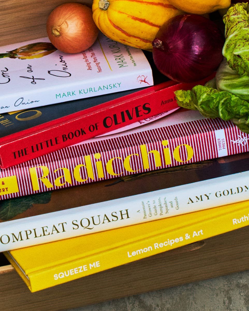 5 Cookbooks That Go Deep on a Single Ingredient A stack of single-subject cookbooks in a box with fall produce